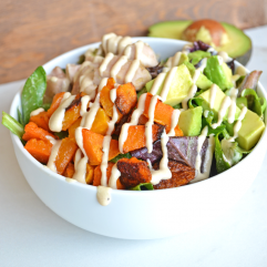 This Paleo Balance Bowl is packed with everything you need to make a perfectly balanced meal in one bowl! Chicken, Butternut Squash & Avocado top greens dressed in a tahini sauce! So tasty and it is paleo & whole 30 approved!