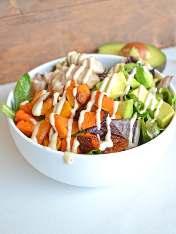 This Paleo Balance Bowl is packed with everything you need to make a perfectly balanced meal in one bowl! Chicken, Butternut Squash & Avocado top greens dressed in a tahini sauce! So tasty and it is paleo & whole 30 approved!