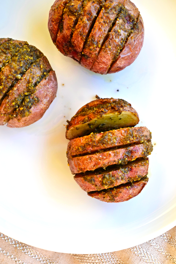Pesto Hasselback Potatoes - I like to use red potatoes for this healthy side dish! Whole30 approved and SO tasty!