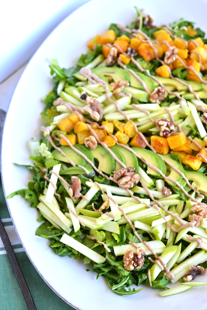 This Fresh Apple Salad with Cinnamon Tahini Drizzle is packed with apples, roasted butternut squash, avocado, walnuts, dressed with apple cider vinaigrette and drizzled with cinnamon tahini sauce! Whole 30 and paleo approved!