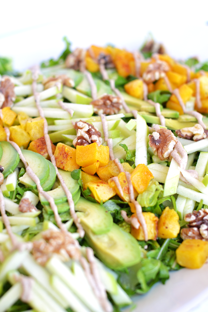 This Fresh Apple Salad with Cinnamon Tahini Drizzle is packed with apples, roasted butternut squash, avocado, walnuts, dressed with apple cider vinaigrette and drizzled with cinnamon tahini sauce! Whole 30 and paleo approved!