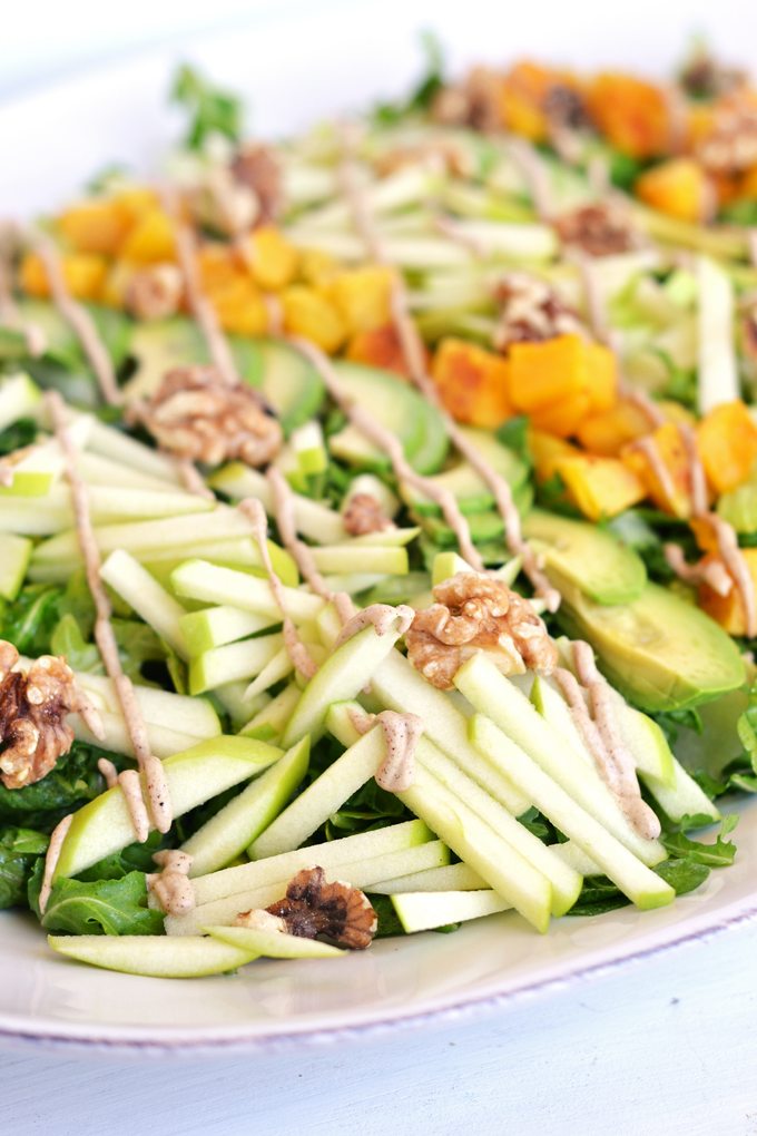 This Fresh Apple Salad with Cinnamon Tahini Drizzle is packed with apples, roasted butternut squash, avocado, walnuts, dressed with apple cider vinaigrette and drizzled with cinnamon tahini sauce! Whole 30 and paleo approved!