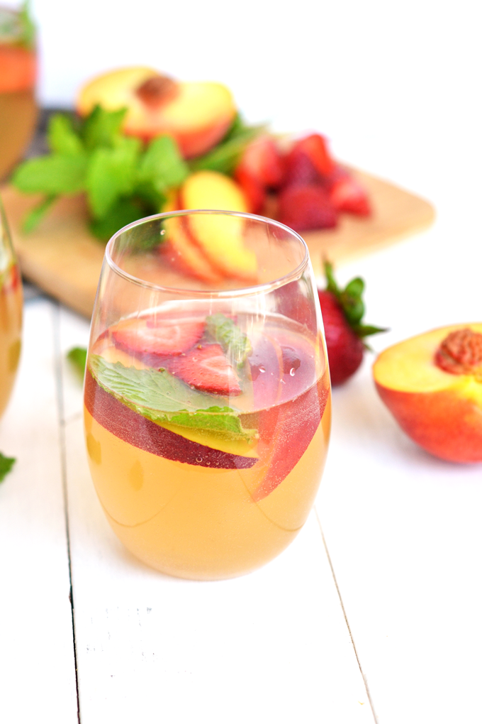 For the perfect mix of health and fun - this Ginger Peach Kombucha Sangria is a great summer drink! 3 simple ingredients and fresh fruits combine in a tasty way!