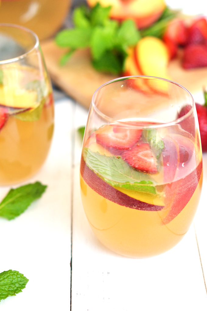 For the perfect mix of health and fun - this Ginger Peach Kombucha Sangria is a great summer drink! 3 simple ingredients and fresh fruits combine in a tasty way!