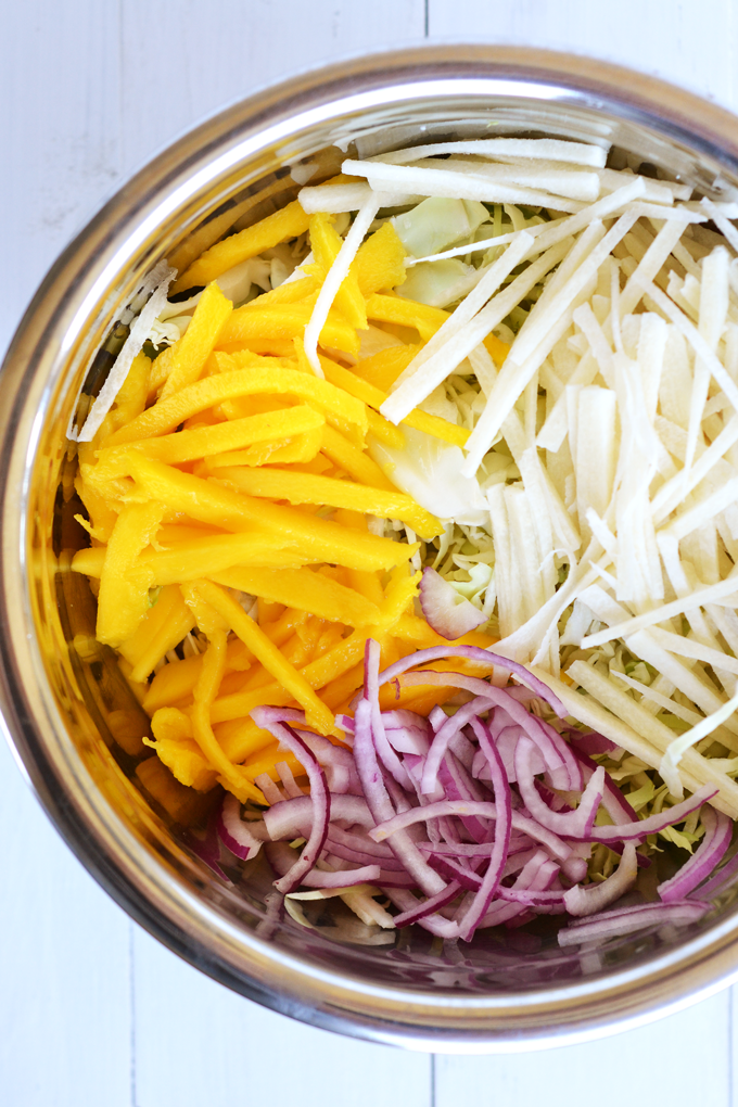 This Mango Jicama Coleslaw is a perfect side dish or topping for a pulled pork sandwich! Nakano Mango Rice Vinegar adds tons of Mango flavor!