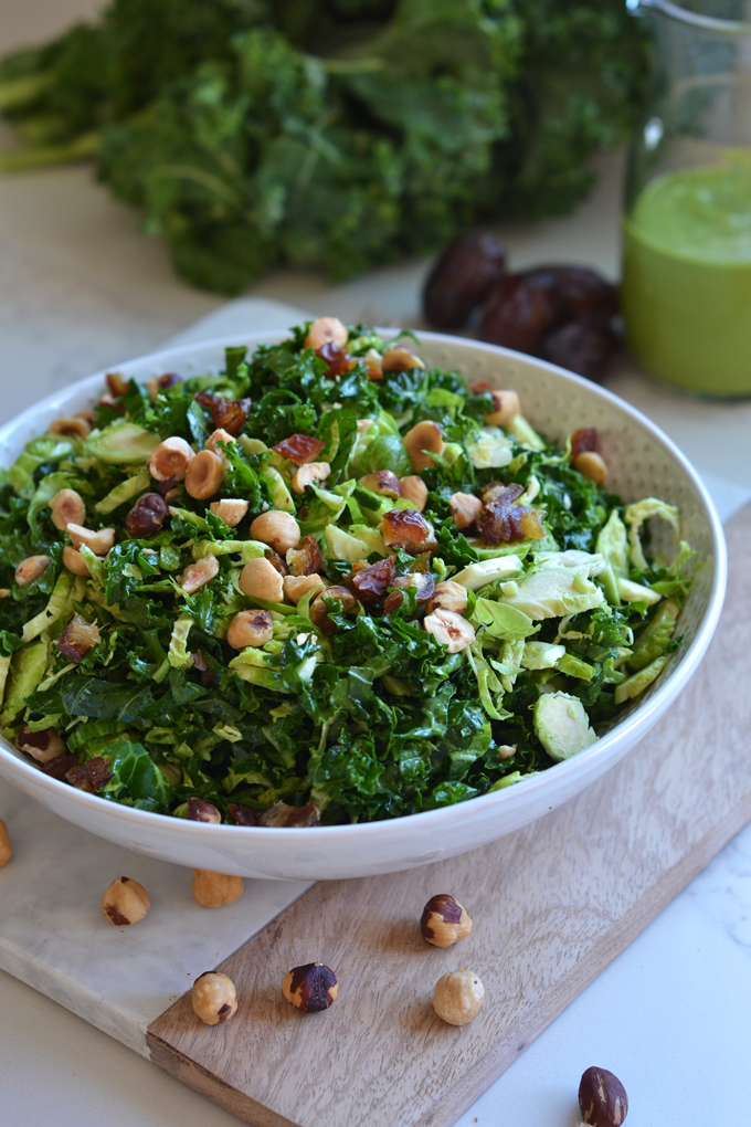 This Shaved Brussels Sprout and Kale Salad has a delicious Sweet Basil Dressing! It is a Whole30 and paleo salad for the summer!