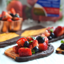 This Chocolate Dipped Sweet Potato Toast with Strawberry Salsa is the perfect way to enjoy sweet potatoes for dessert!! The simple strawberry salsa is made with California Giant Berry Farms strawberries and blueberries and tossed with honey and mint!