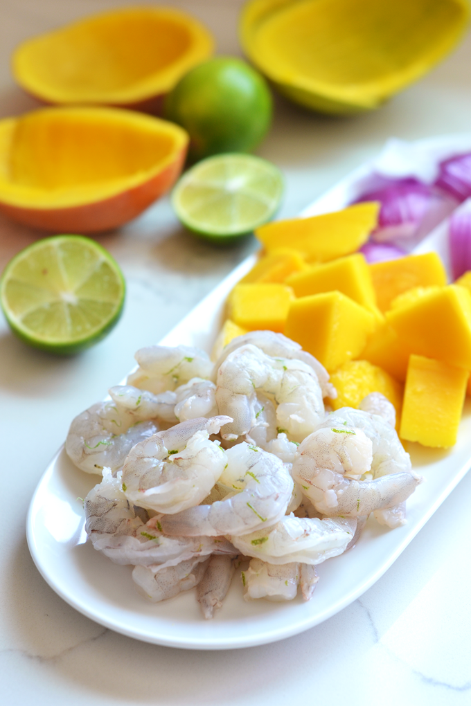 These Grilled Mango Shrimp Skewers are the perfect fresh and healthy way to barbecue this Summer! A cilantro lime sauce finishes it off beautifully!