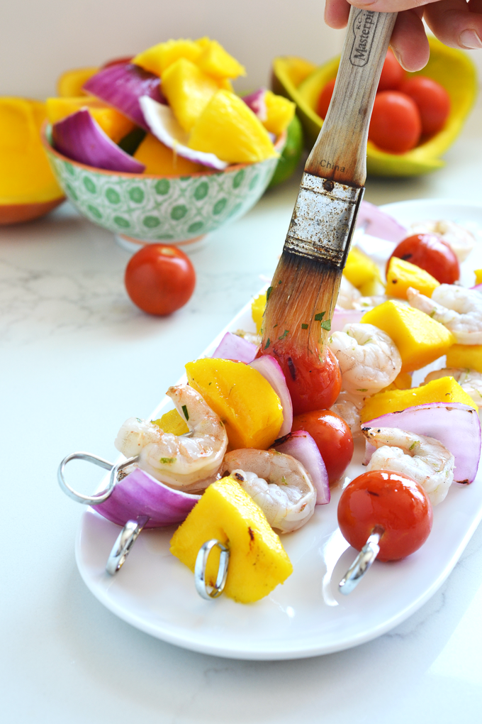 These Grilled Mango Shrimp Skewers are the perfect fresh and healthy way to barbecue this Summer! A cilantro lime sauce finishes it off beautifully!