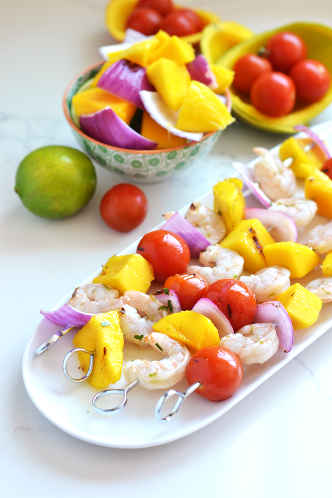 These Grilled Mango Shrimp Skewers are the perfect fresh and healthy way to barbecue this Summer! A cilantro lime sauce finishes it off beautifully!