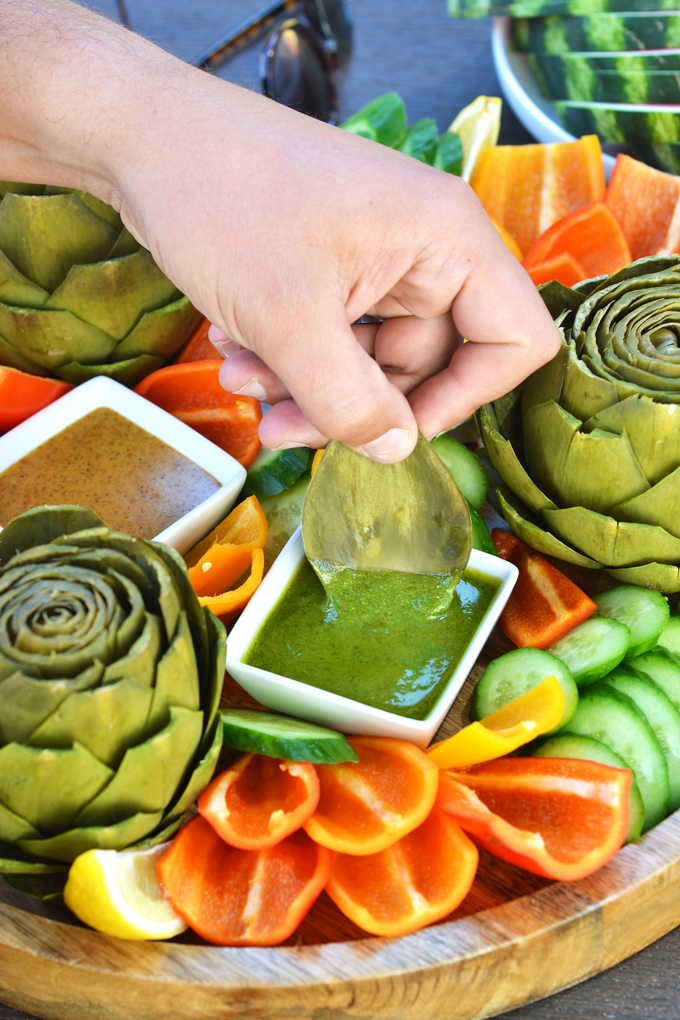 This Whole30 Artichoke Platter is the perfect appetizer to bring to a potluck or barbecue this summer or any time of the year! Complete with 3 whole30 dipping sauces!