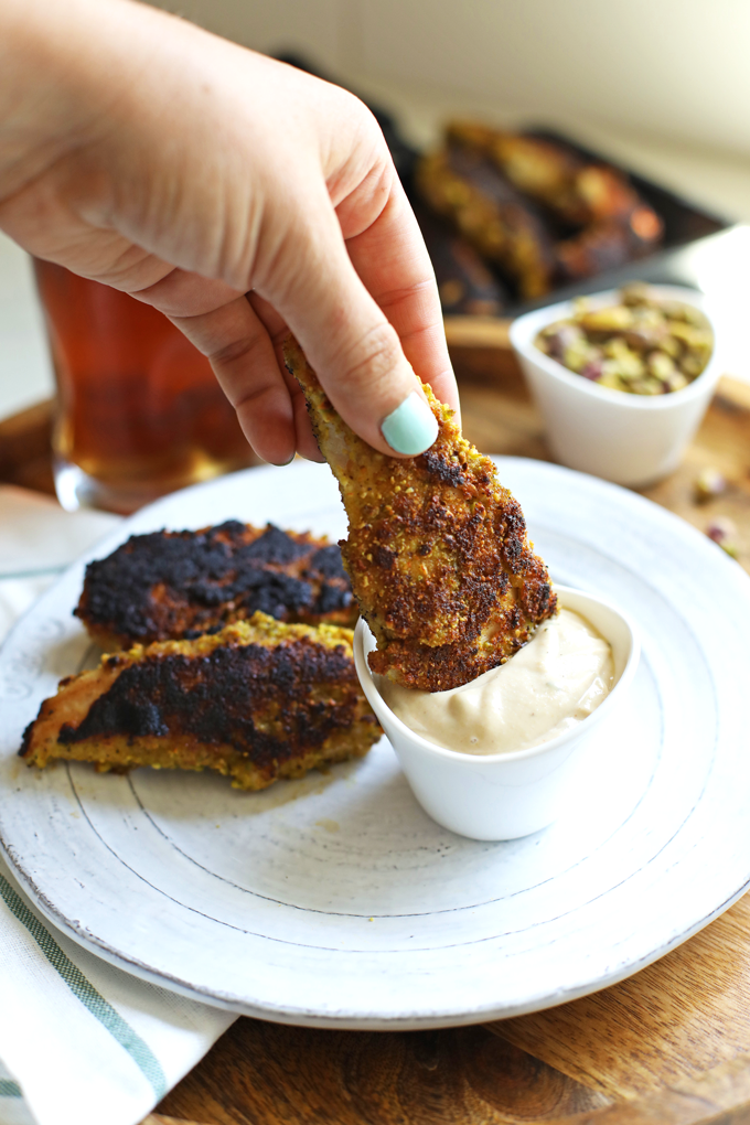 These Garlic Pistachio Chicken Tenders with Rosemary Tahini Dipping Sauce are Whole30 and perfect for an easy weeknight dinner!