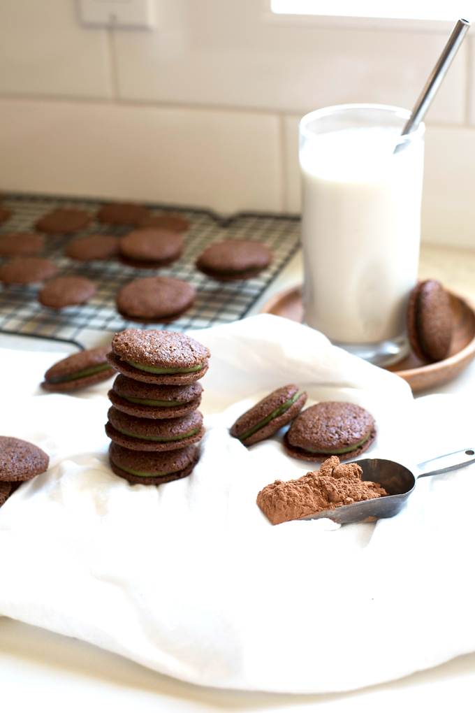 These Grain Free Chocolate Mint Sandwich Cookies are the best treat for any time of year! The filling is sweetened with maple syrup and gets its green color from spinach!