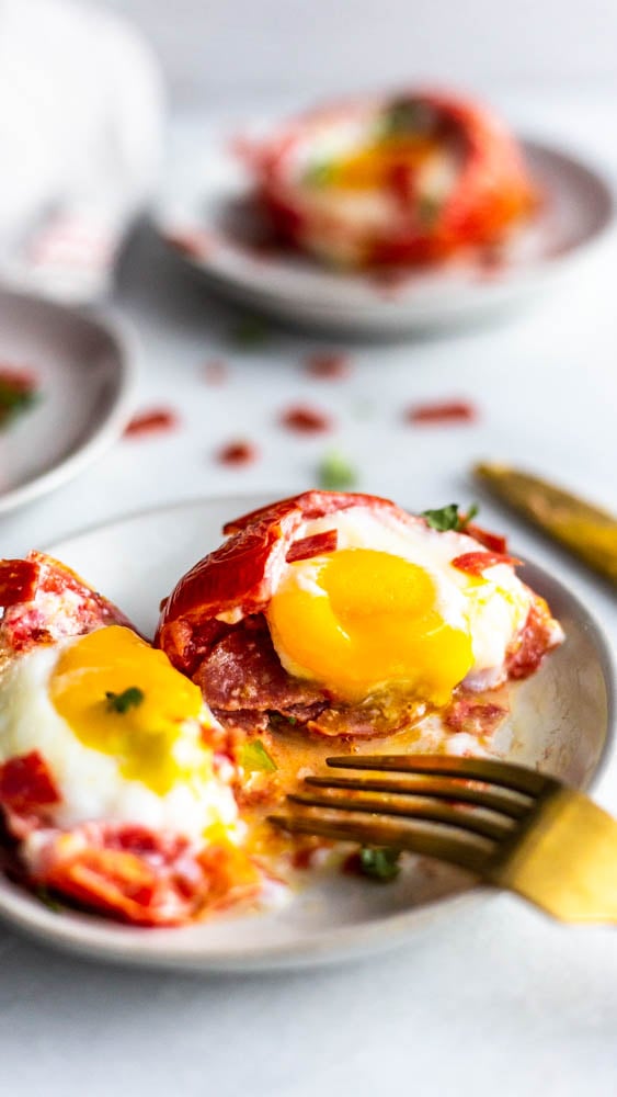 These Pizza Baked Eggs are a super simple breakfast idea. Stuff a tomato with pepperoni and an egg and bake for a gluten and dairy free life hack. 