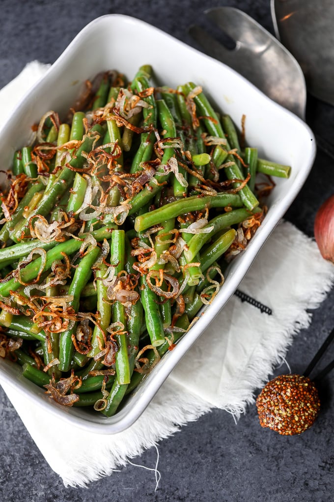 These Green Beans with Sweet Dijon Sauce and Crispy Shallots are a super easy paleo side dish that everyone will love!