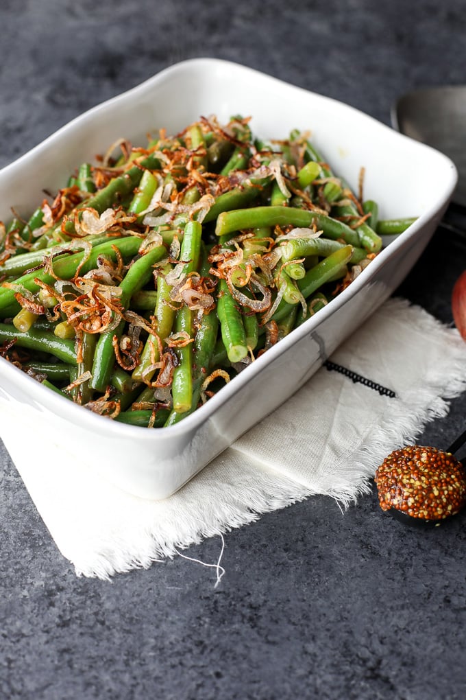 These Green Beans with Sweet Dijon Sauce and Crispy Shallots are a super easy paleo side dish that everyone will love!