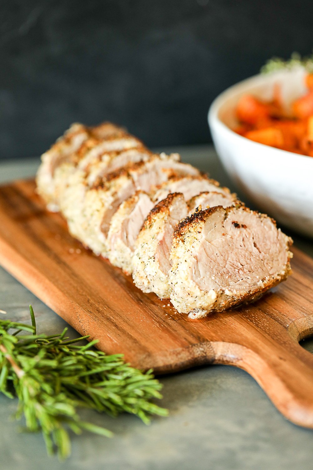 This Garlic Rosemary Crusted Pork Tenderloin is simple enough for a weeknight but flavorful enough for a main event! It is packed with flavor and the whole30 breading keeps it nice and moist!