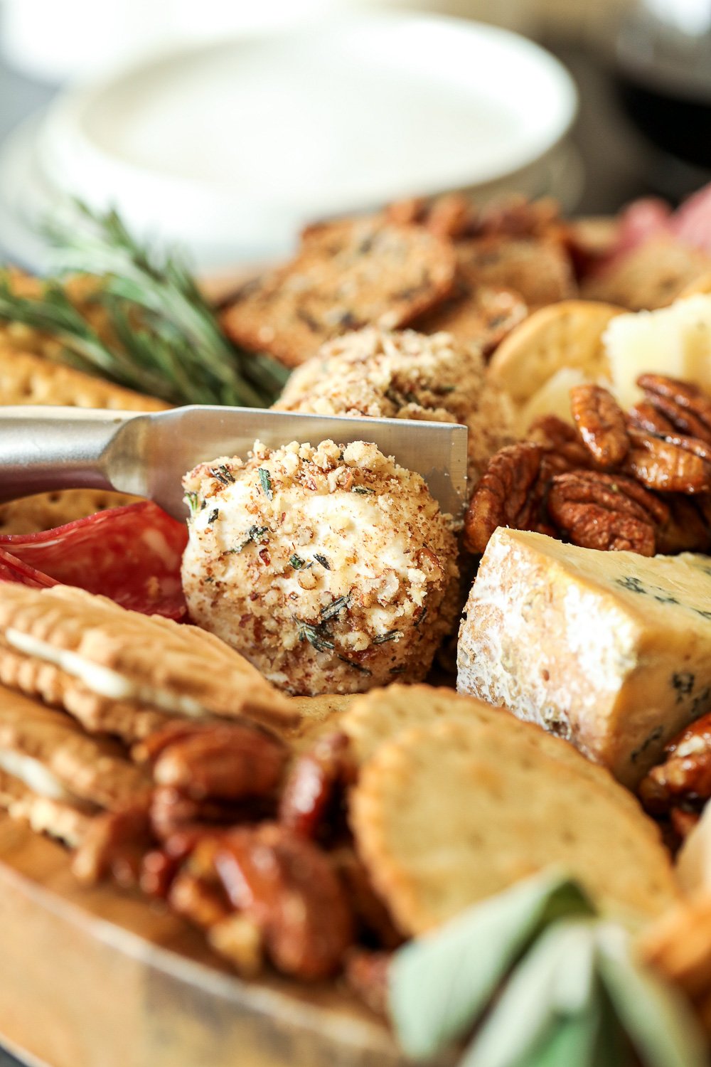 This Pecan-Packed Holiday Charcuterie Board has Maple Sage Pecans, a Rosemary Pecan Crusted Goat Cheese and a Honey Cinnamon Pecan spread that will wow any crowd this holiday!