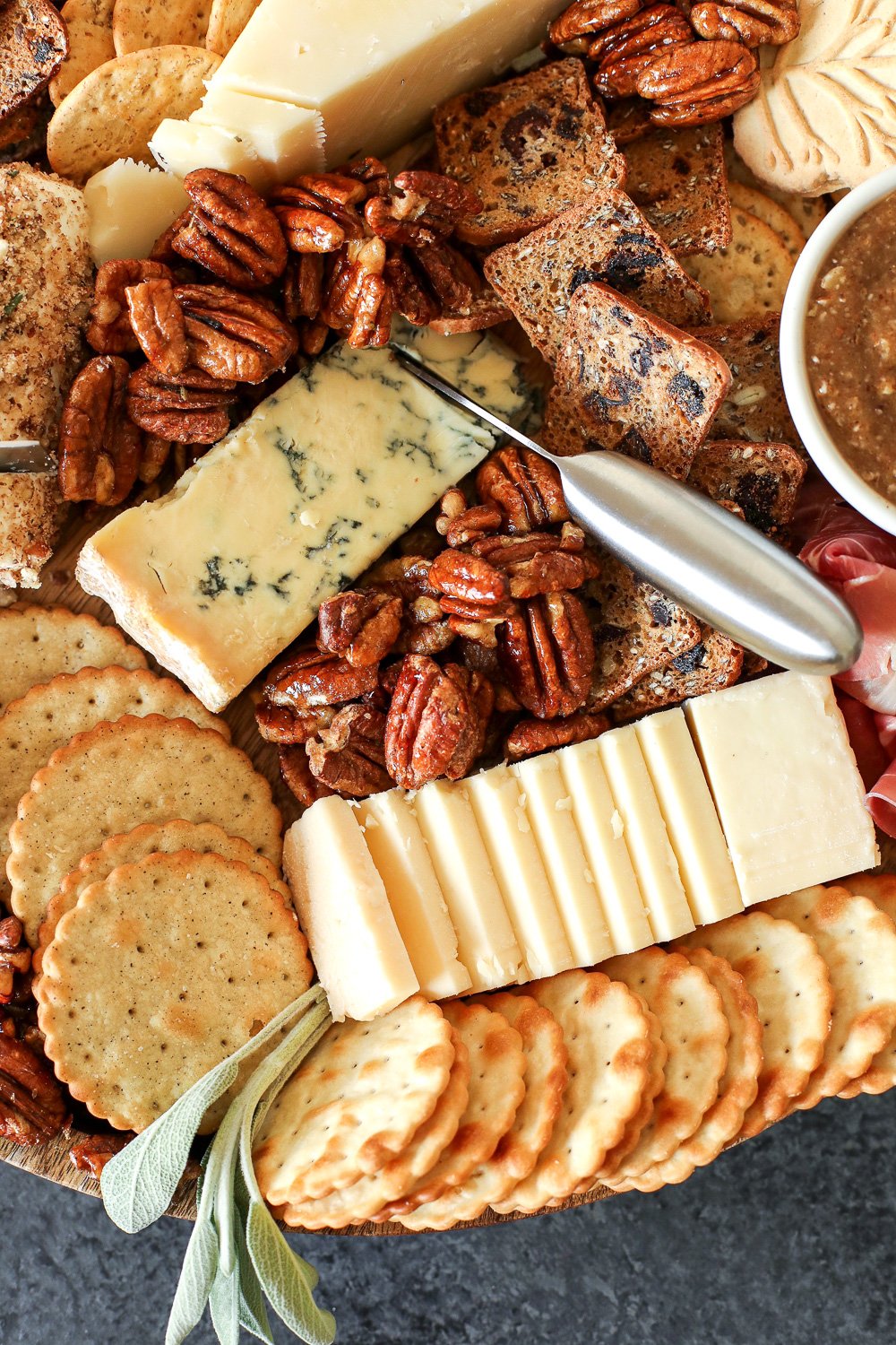 This Pecan-Packed Holiday Charcuterie Board has Maple Sage Pecans, a Rosemary Pecan Crusted Goat Cheese and a Honey Cinnamon Pecan spread that will wow any crowd this holiday!