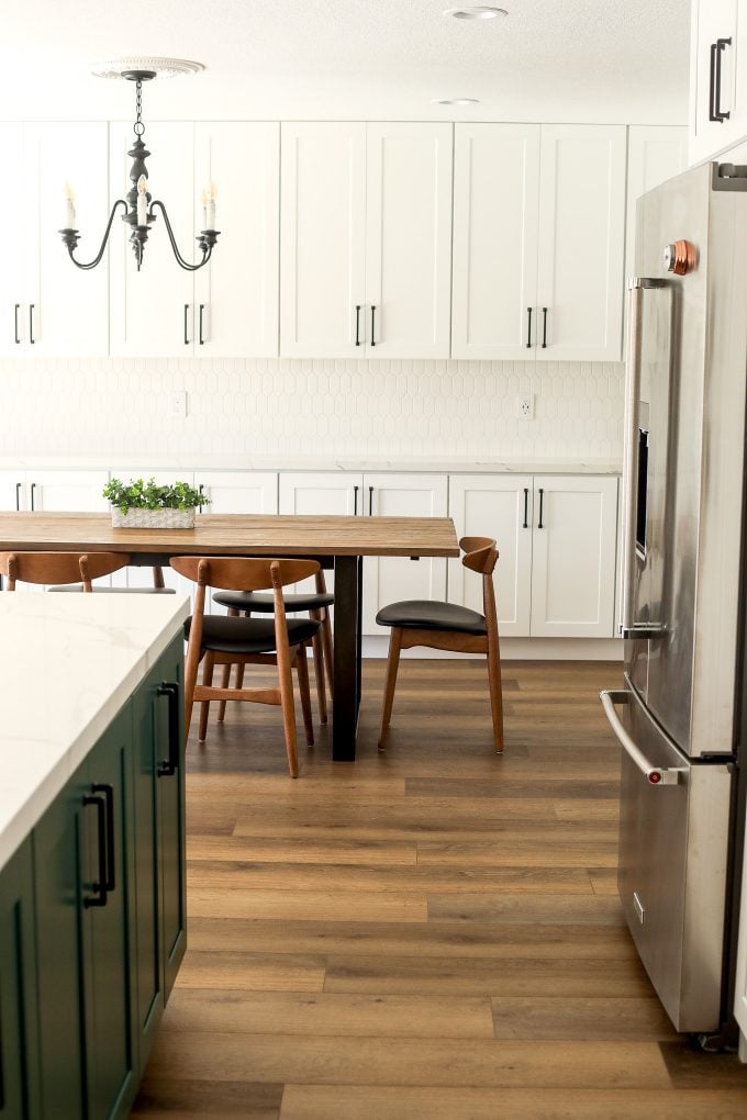 2020 Kitchen Remodel with a green island and surrounding white cabinets.