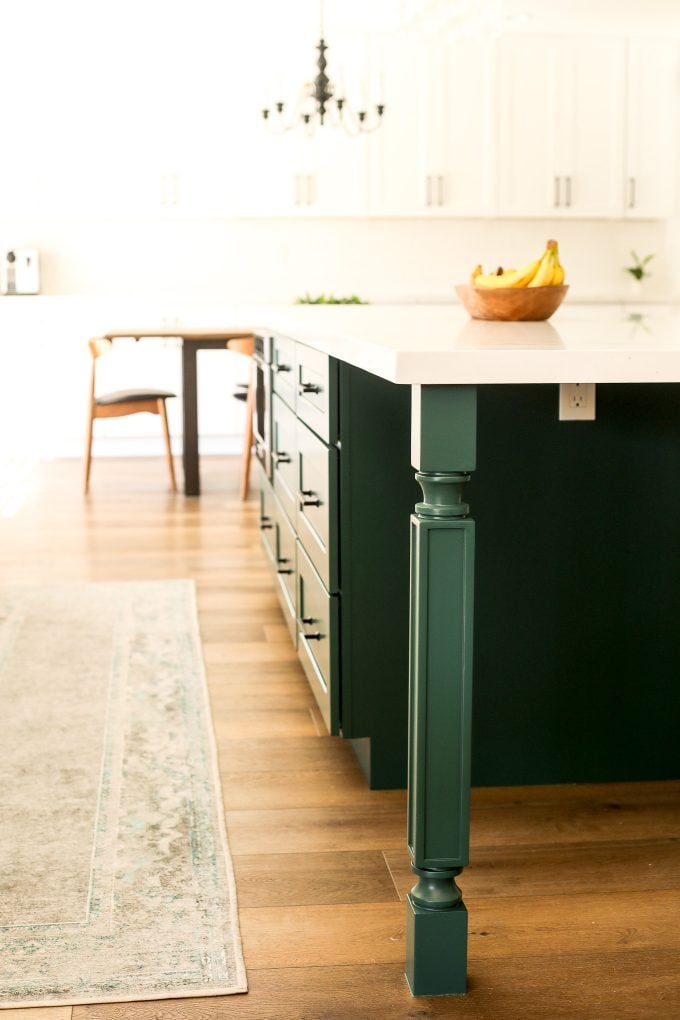 2020 Kitchen Remodel with a green island and surrounding white cabinets.