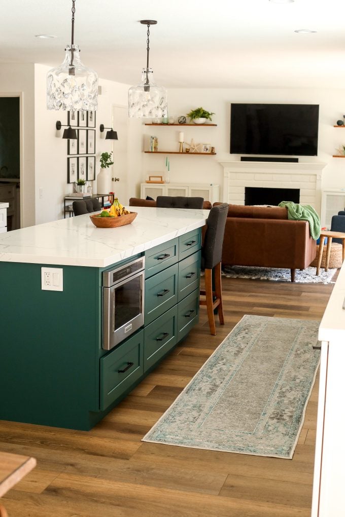 2020 Kitchen Remodel with a green island and surrounding white cabinets.