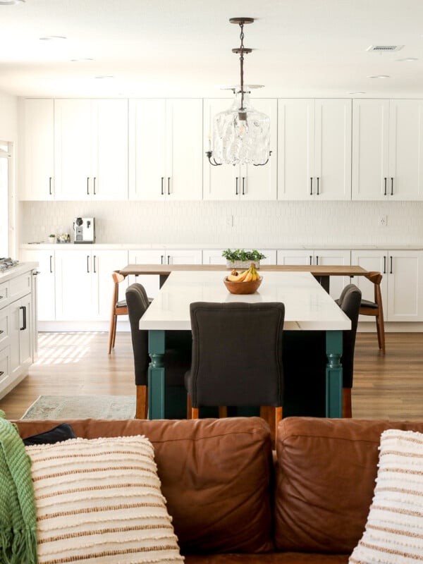 2020 Kitchen Remodel with a green island and surrounding white cabinets.