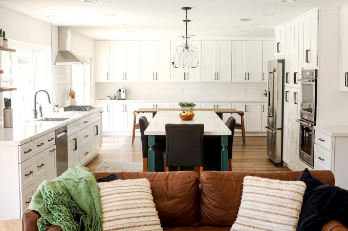 2020 Kitchen Remodel with a green island and surrounding white cabinets.