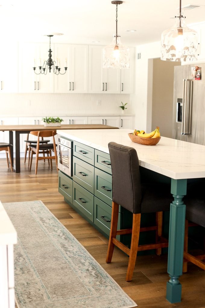 2020 Kitchen Remodel with a green island and surrounding white cabinets.