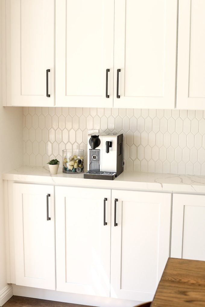 2020 Kitchen Remodel with a green island and surrounding white cabinets.