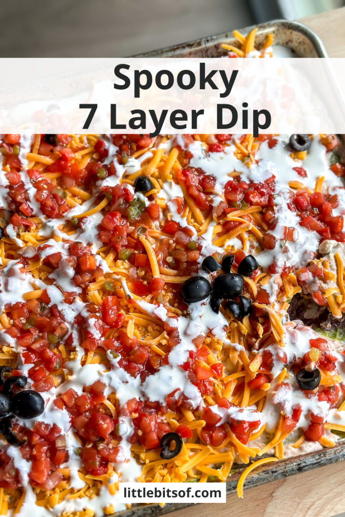 This Spooky 7 Layer Dip is great for a crowd and made on a sheet pan!