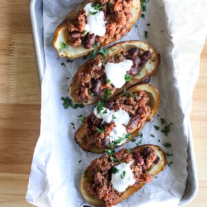 These healthier chili potato skins are perfect football food or can be a full meal any night of the week!