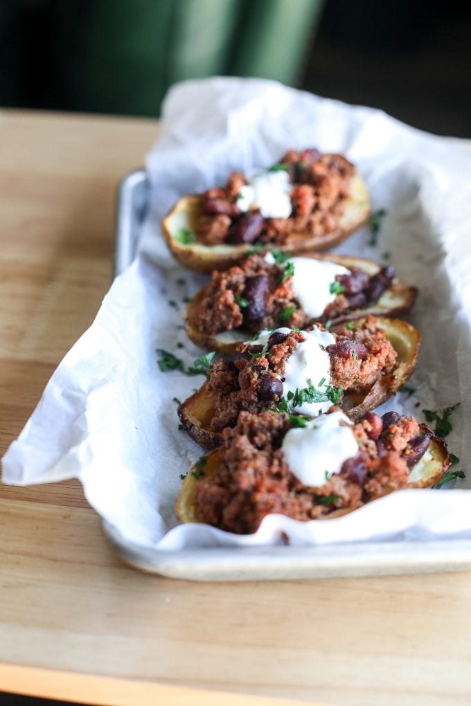 These healthier chili potato skins are perfect football food or can be a full meal any night of the week!