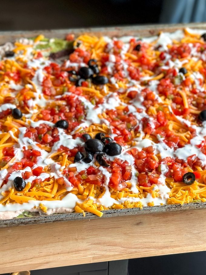 This Spooky 7 Layer Dip is great for a crowd and made on a sheet pan!