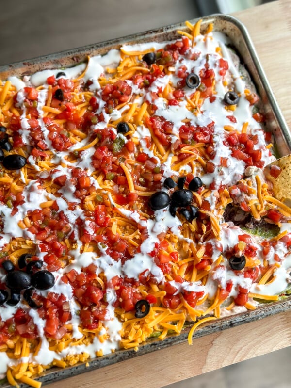 This Spooky 7 Layer Dip is great for a crowd and made on a sheet pan!