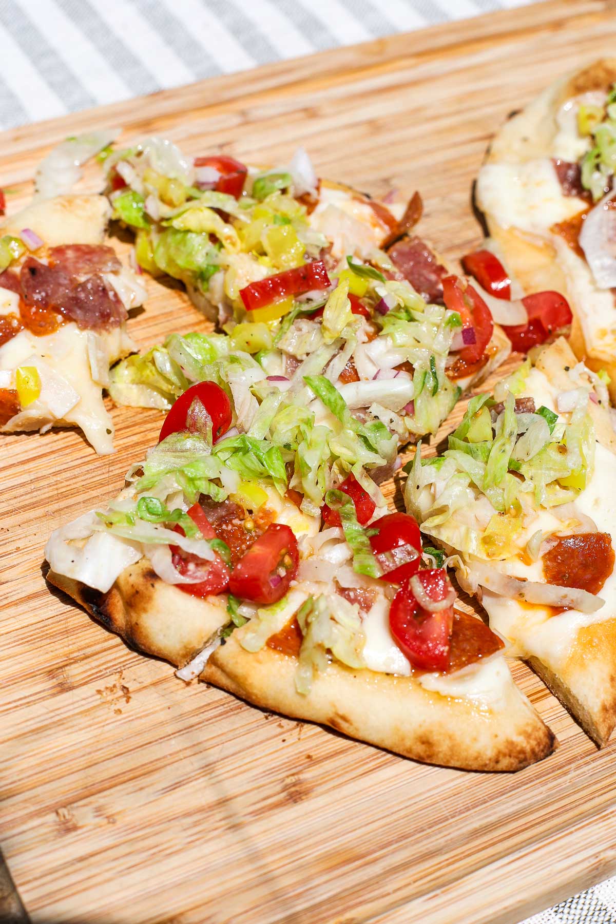 Savor our Italian Grinder Flatbread! Loaded with Italian meats, cheese, and veggies for a perfect, easy-to-make meal.