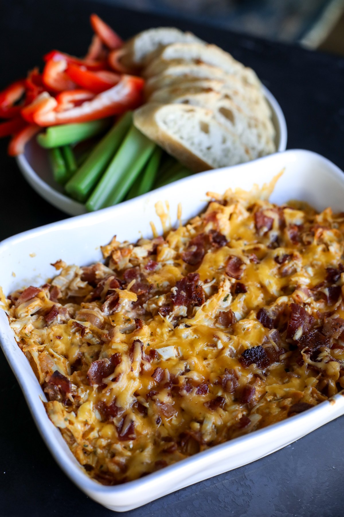 This High Protein Buffalo Chicken Bacon Ranch Dip is the perfect game day snack! Packed with flavor and protein, it's low-carb and keto-friendly.