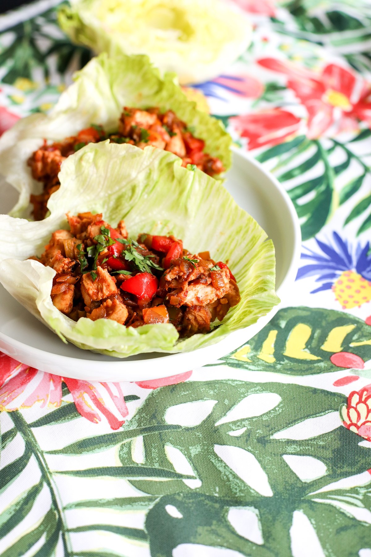 Easy & healthy chopped fajita lettuce cups recipe! Flavorful chicken & veggies in crisp lettuce. Perfect for a quick, low-carb meal.