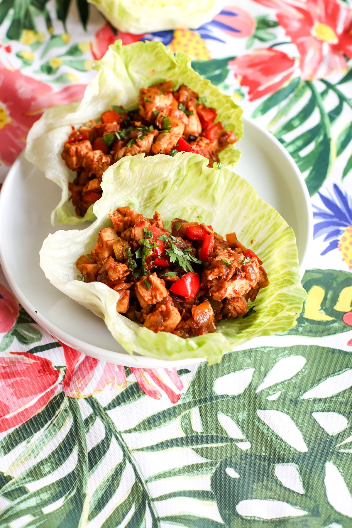Easy & healthy chopped fajita lettuce cups recipe! Flavorful chicken & veggies in crisp lettuce. Perfect for a quick, low-carb meal.