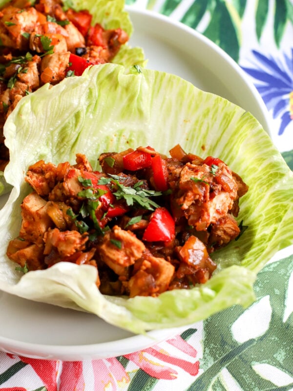 Easy & healthy chopped fajita lettuce cups recipe! Flavorful chicken & veggies in crisp lettuce. Perfect for a quick, low-carb meal.