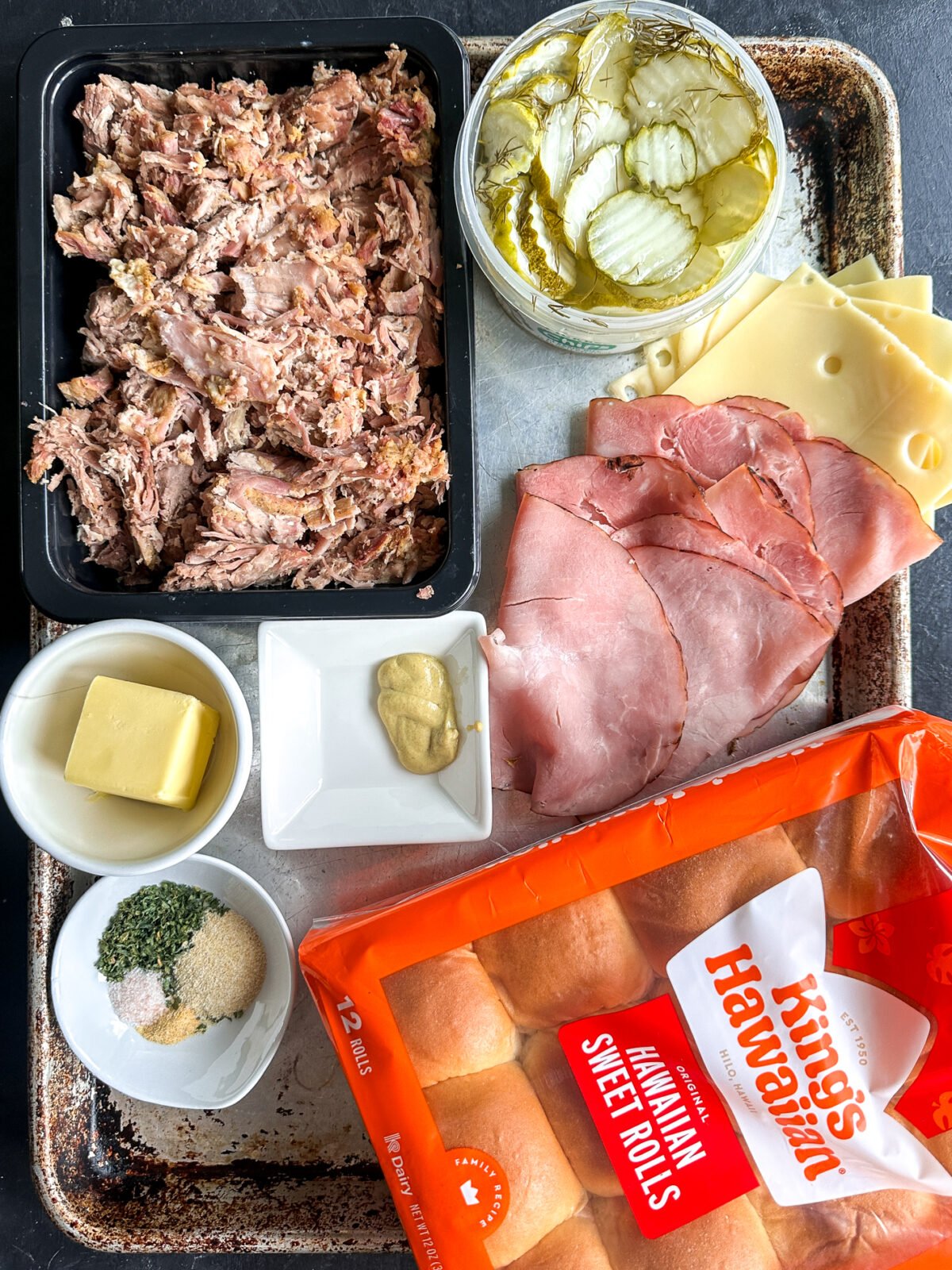 Melted Swiss cheese, savory ham, & slow-cooked pulled pork on sweet Hawaiian rolls. These Cuban sliders are a crowd-pleasing party hit!