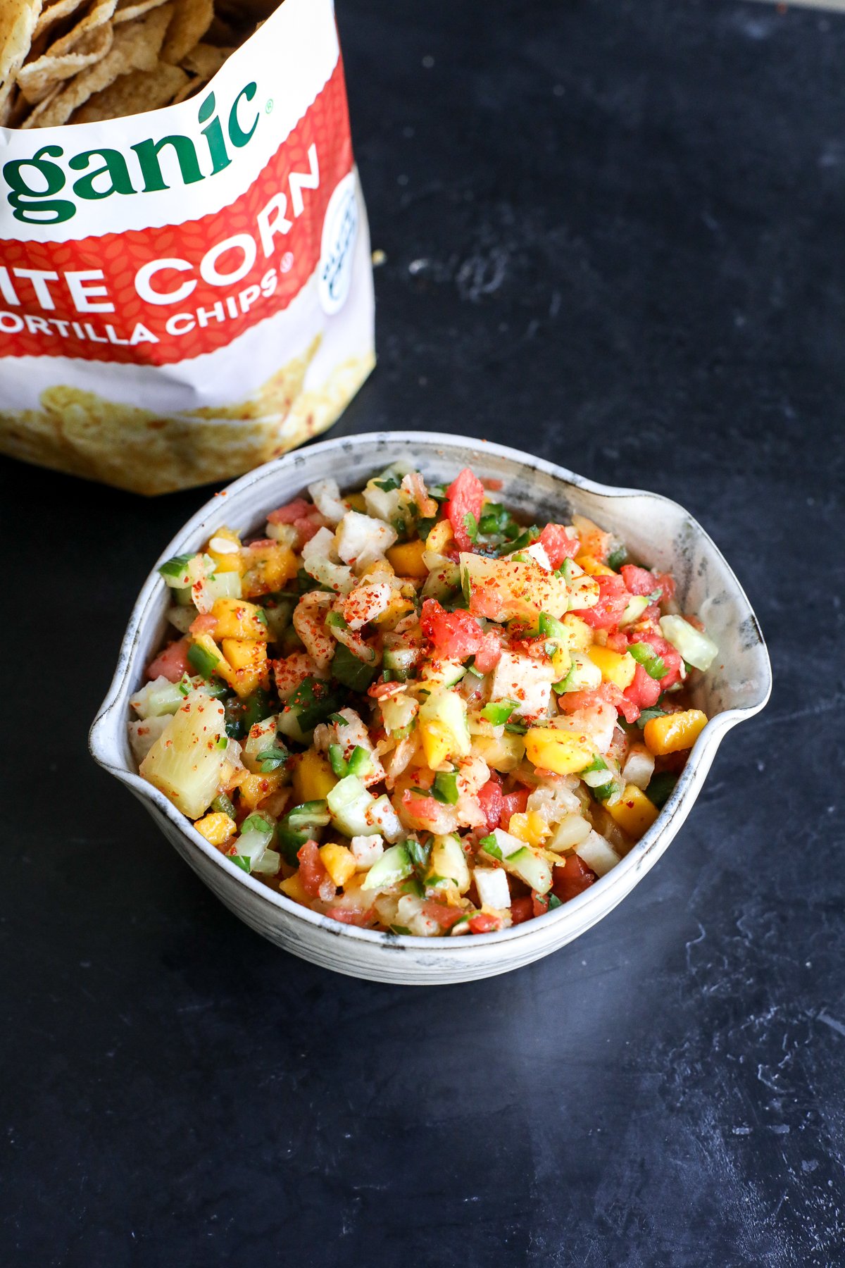 Dive into this vibrant street cart fruit salsa! Made with sweet mango, watermelon, and pineapple, plus a zesty kick from lime, Tajín, and jalapeño. The perfect summer snack or taco topping!