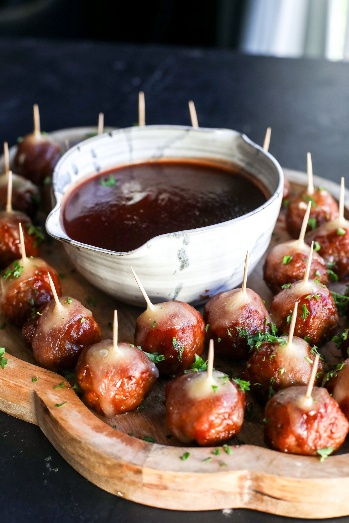Holiday perfection: Cranberry, BBQ, and savory meatballs baked with a creamy slice of melted brie cheese.