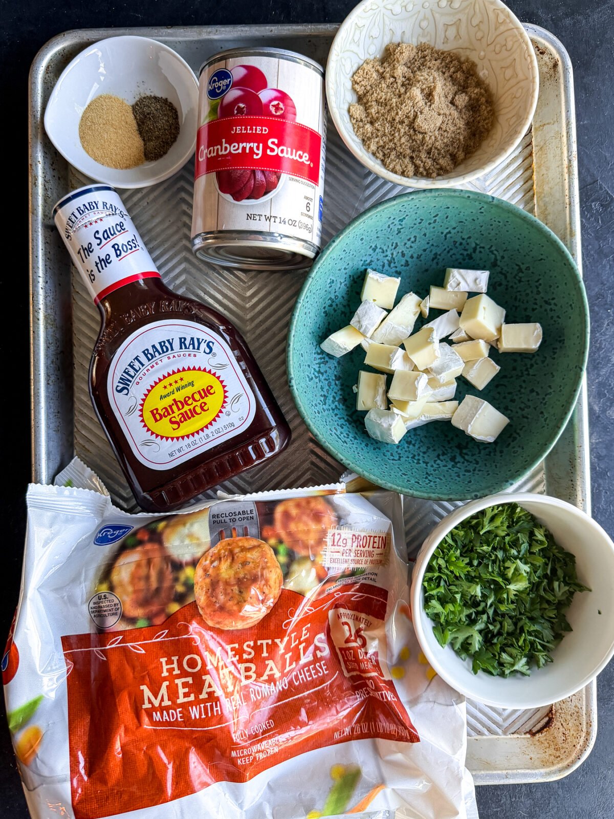 Holiday perfection: Cranberry, BBQ, and savory meatballs baked with a creamy slice of melted brie cheese.