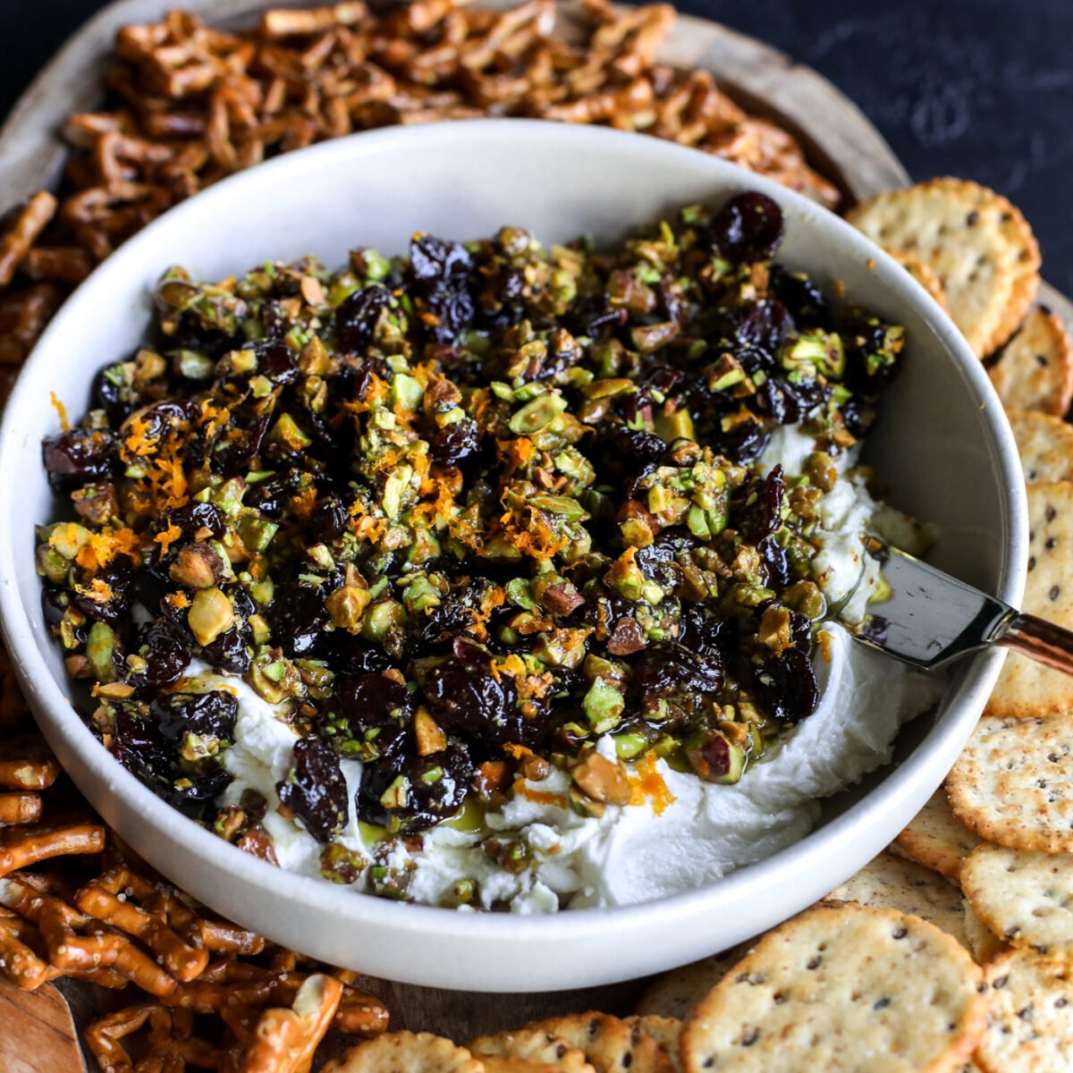 Sweet, savory, and perfect for a party! Whipped goat cheese topped with warm honey-glazed pistachios and dried cherries.