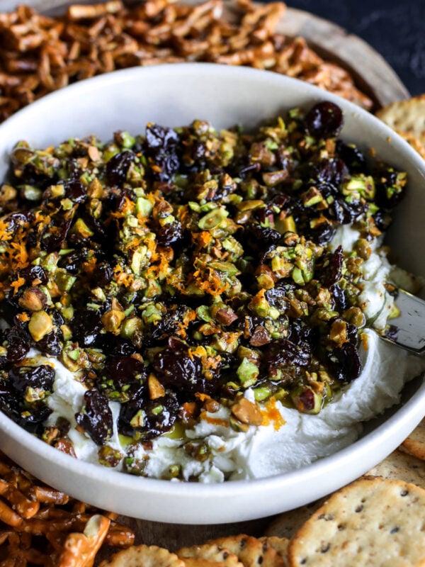 Sweet, savory, and perfect for a party! Whipped goat cheese topped with warm honey-glazed pistachios and dried cherries.