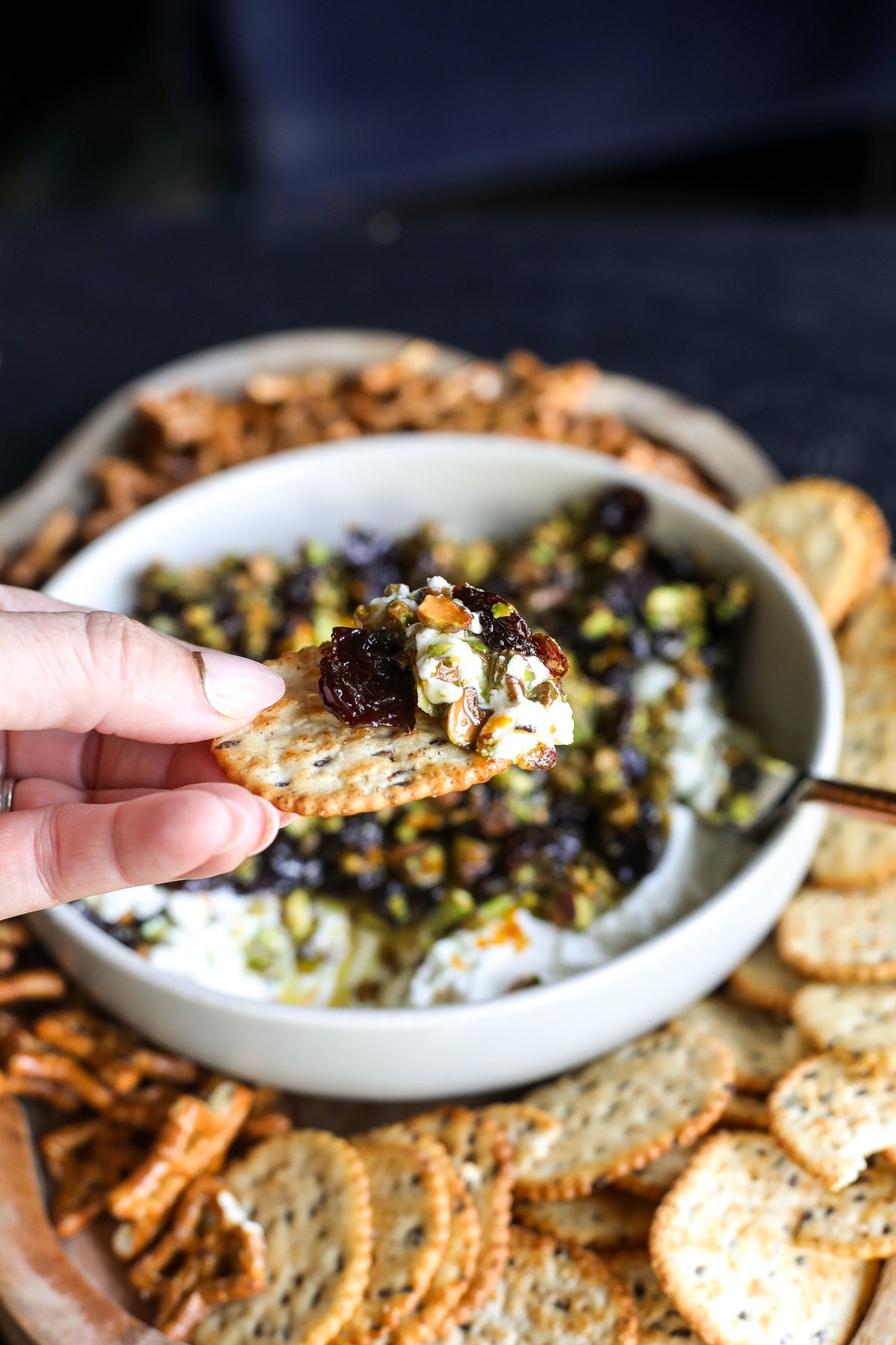 Sweet, savory, and perfect for a party! Whipped goat cheese topped with warm honey-glazed pistachios and dried cherries.