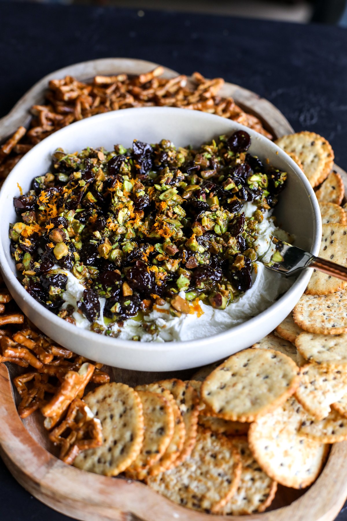 Sweet, savory, and perfect for a party! Whipped goat cheese topped with warm honey-glazed pistachios and dried cherries.