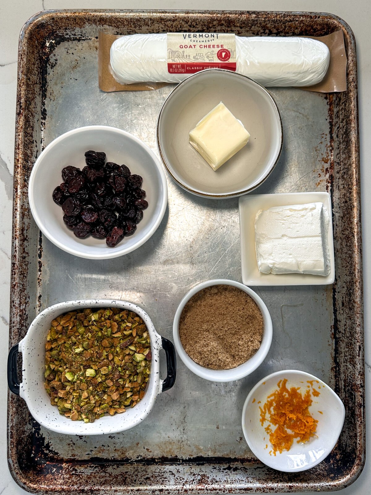 Sweet, savory, and perfect for a party! Whipped goat cheese topped with warm honey-glazed pistachios and dried cherries.