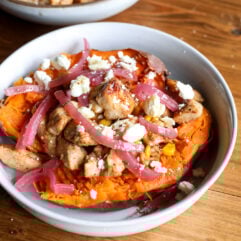 Sweet, spicy, and healthy! Hot honey chicken and toasted corn stuffed in roasted sweet potatoes with feta and arugula.